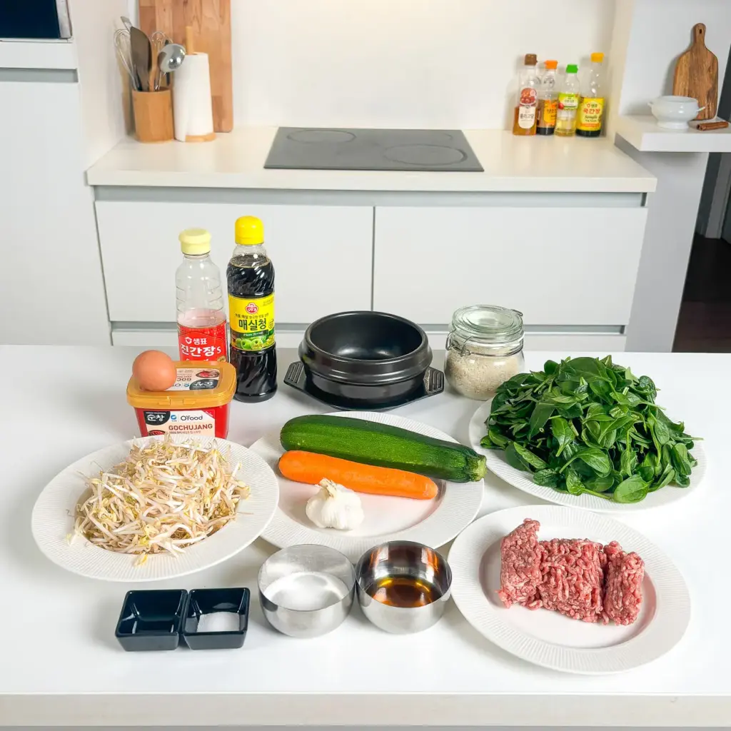 dolsot bibimbap ingredients - spinach bean sprouts carrot zucchini meat and egg