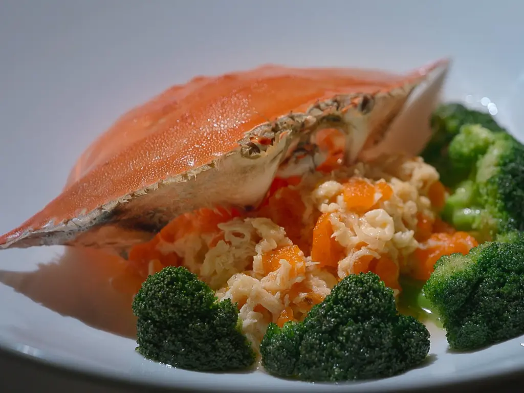 Broccoli with orange diced vegetables.