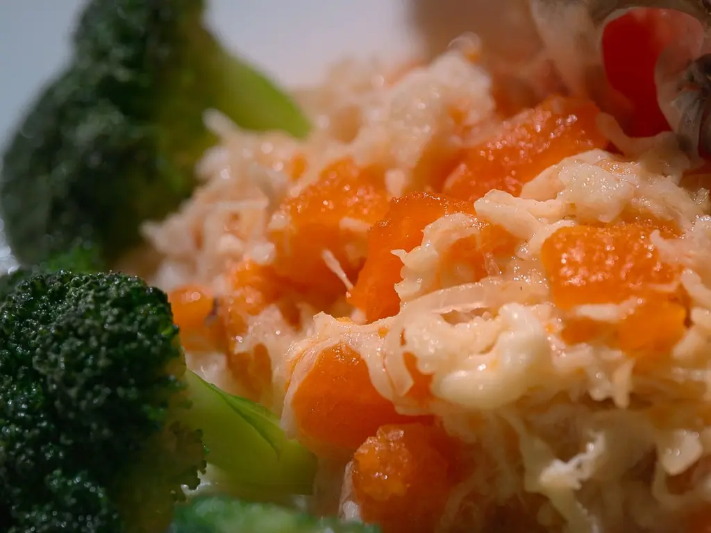 Broccoli with orange diced vegetables.