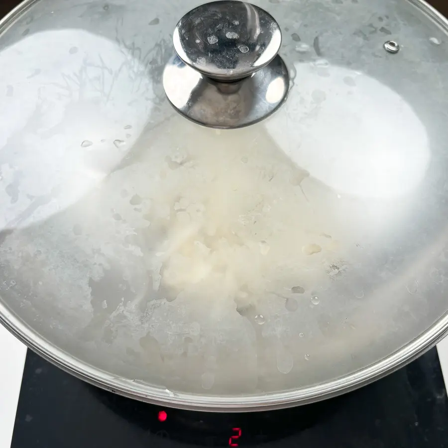 Easy Korean Radish Side Dish (Mu Namul Recipe) with Perilla Seeds Adding water to steam the Korean radish with perilla seeds.