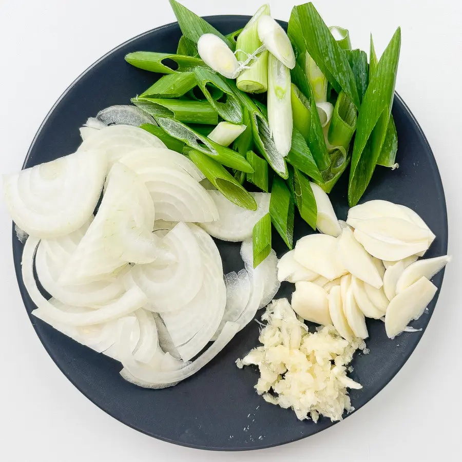 Sliced garlic minced garlic green onion and julienned onion prepped for Korean stir fry