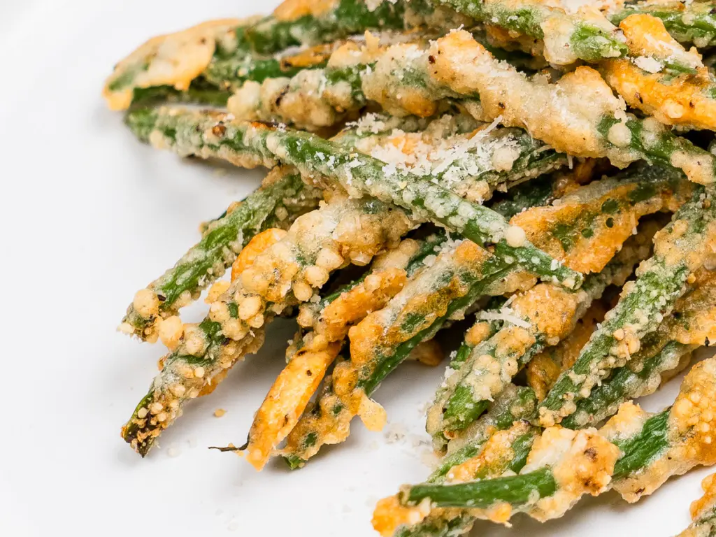 close up of cheese green beans — crispy parmesan crust texture