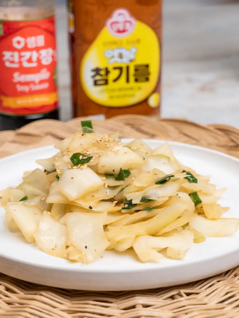 Step 3 of making Korean cabbage stir fry: add soy sauce and tuna fish sauce together.