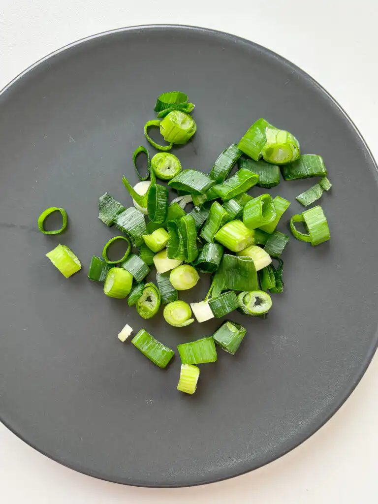 chop green onion for Korean weight loss recipe with cabbage