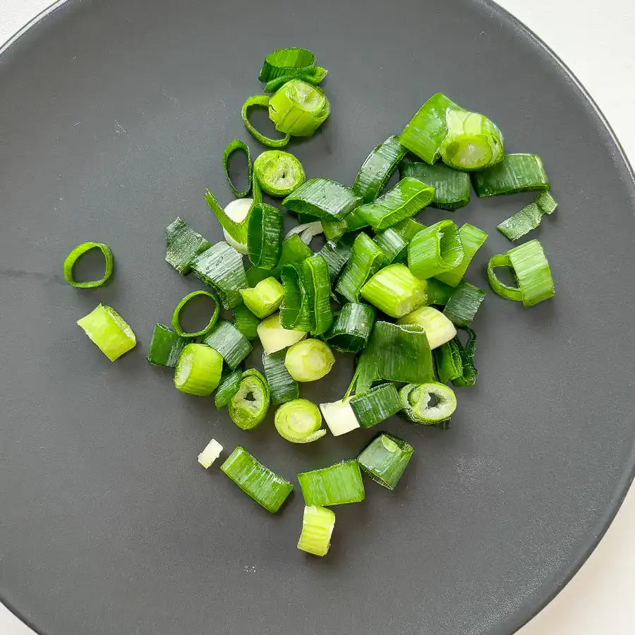 chop green onion for Korean weight loss recipe with cabbage