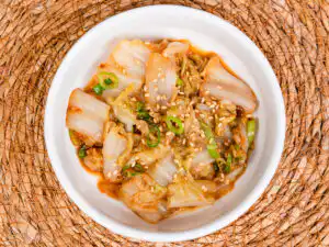 korean cabbage banchan baechu namul close up showing glossy doenjang sauce coating on tender napa cabbage