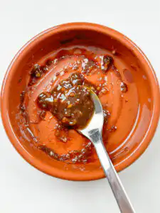 doenjang sauce mixed in a small ceramic bowl with garlic sesame oil and plum syrup for baechu namul