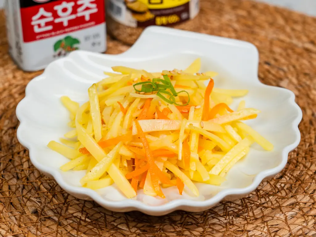 Gamja bokkeum Korean potato side dish stir fried to golden perfection with julienned carrots