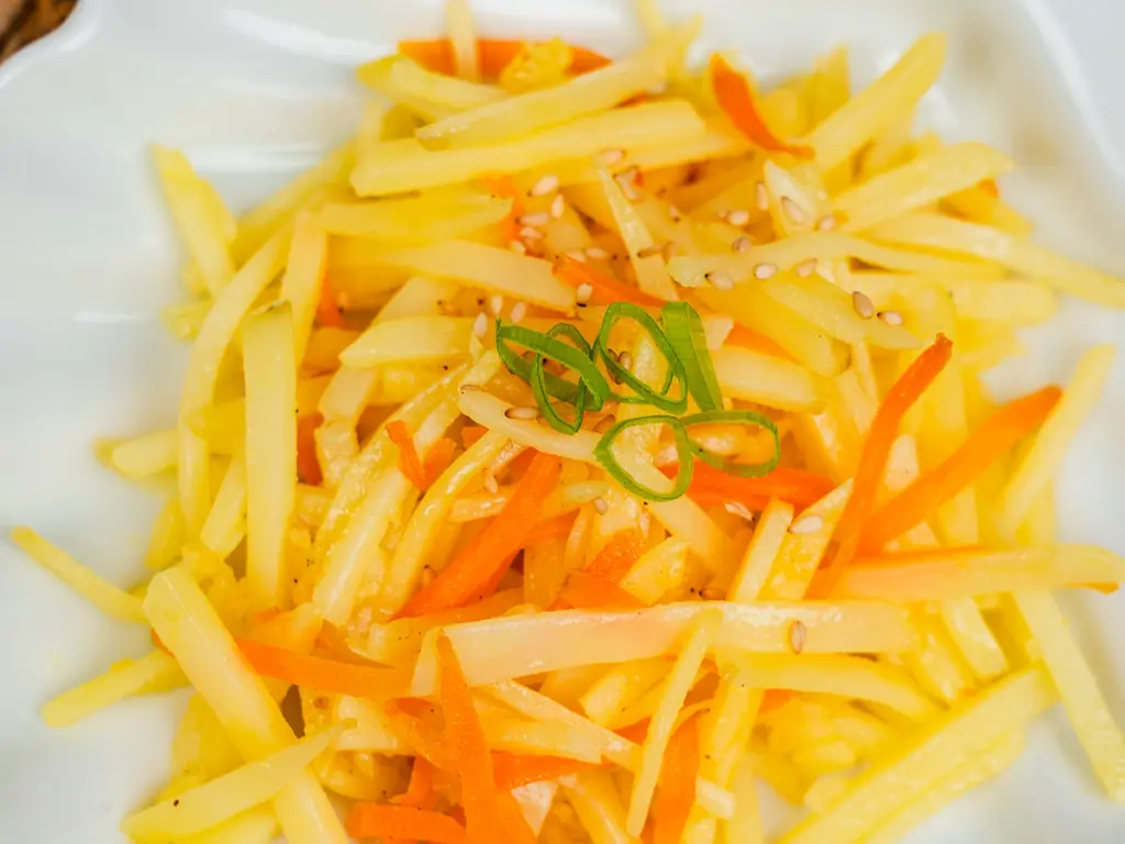 Close-up of Korean potato side dish gamja bokkeum showing crispy golden edges and tender center
