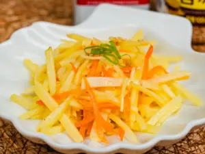 Gamja bokkeum Korean potato side dish garnished with roasted sesame seeds and green onion