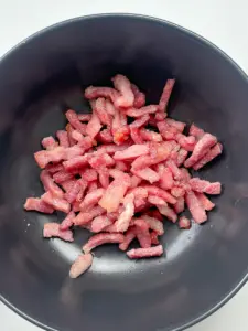 bacon rendering in pan leaving behind golden fat for napa cabbage side dish