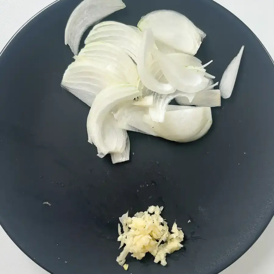 Thinly sliced onion and minced garlic prepared for eomuk bokkeum