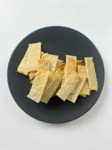 Korean fish cake sheets being cut into 2cm strips