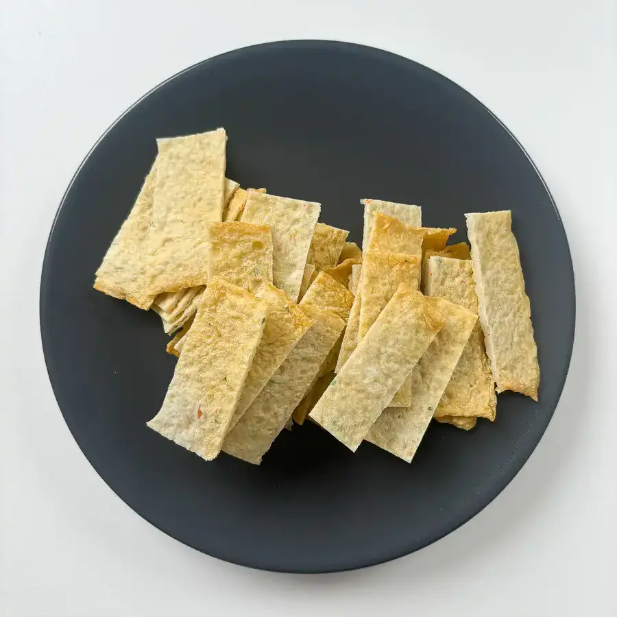 Korean fish cake sheets being cut into 2cm strips