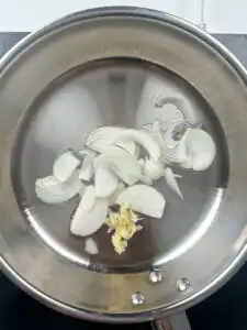 Garlic and onion sautéing in oil over low heat in a pan