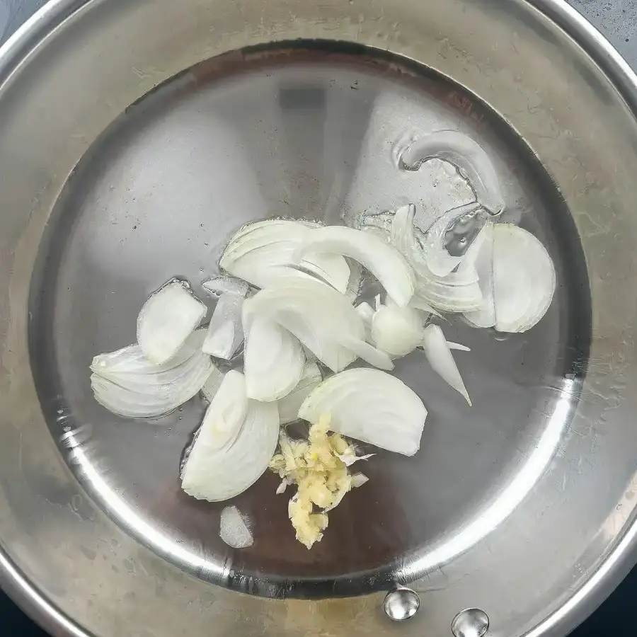 Garlic and onion sautéing in oil over low heat in a pan