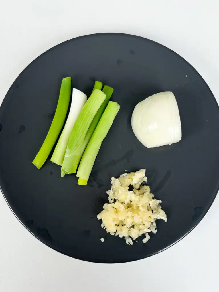 Minced daepa green onion and onion in a food chopper for Korean beef patties