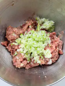 Minced daepa green onion and onion in a food chopper for Korean beef patties