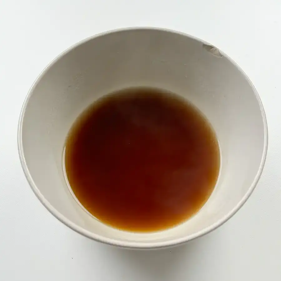 Sweet soy glaze being poured over pan-fried tteokgalbi