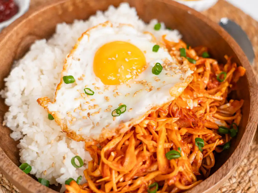 Bibimbap bowl with gochugaru cabbage and sesame seeds close up