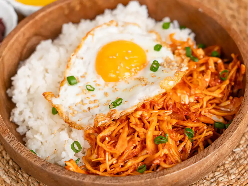 Simple Korean rice bowl with spicy cabbage and egg yolk