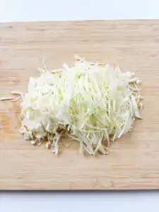 Cut cabbage thinly for spicy cabbage bibimbap