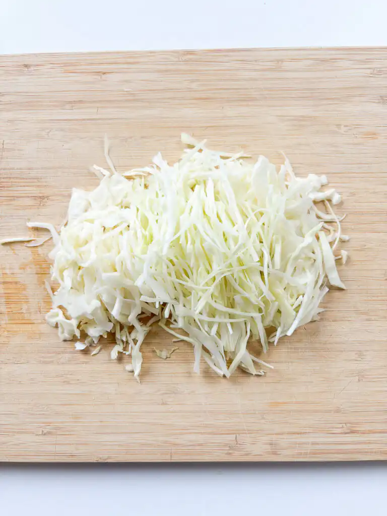 Cut cabbage thinly for spicy cabbage bibimbap