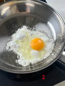 Frying an egg in a pan with crispy edges