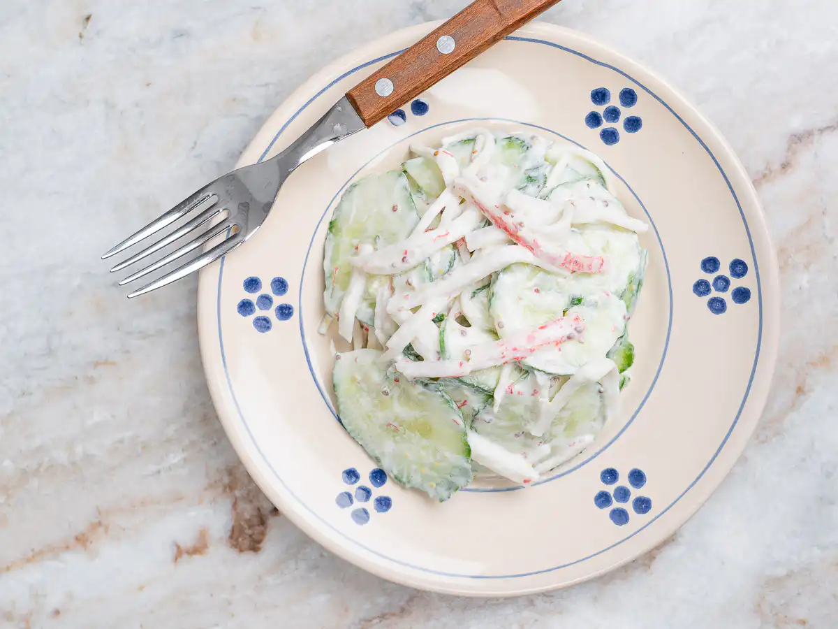 close up texture shot of creamy cucumber salad with greek yogurt dressing