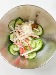 sliced cucumber and shredded crab sticks before tossing in dressing