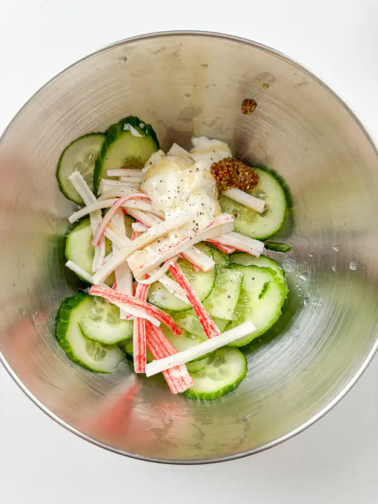 sliced cucumber and shredded crab sticks before tossing in dressing