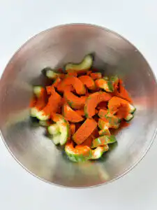 Cubed cucumber kimchi - 30Min Quick Kimchi Recipe Gochugaru being added to cucumber cubes before wet ingredients