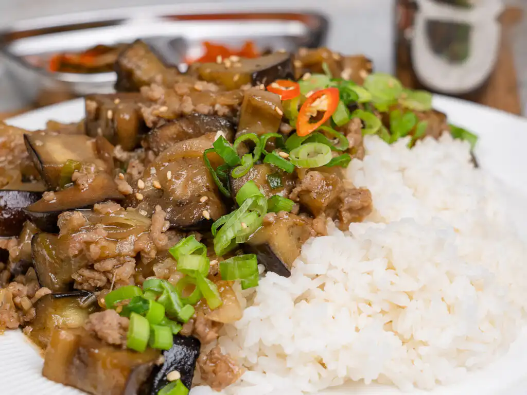 Eggplant ground meat recipe served in a deep bowl with green onion topping