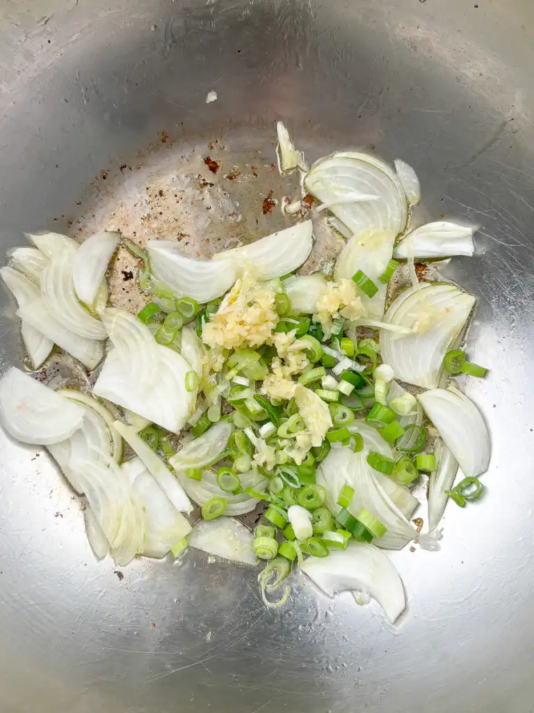 Let the green onion and garlic bloom slowly in the oil before adding anything else.