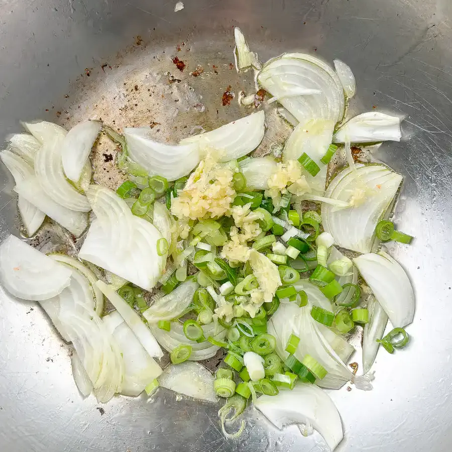 Let the green onion and garlic bloom slowly in the oil before adding anything else.