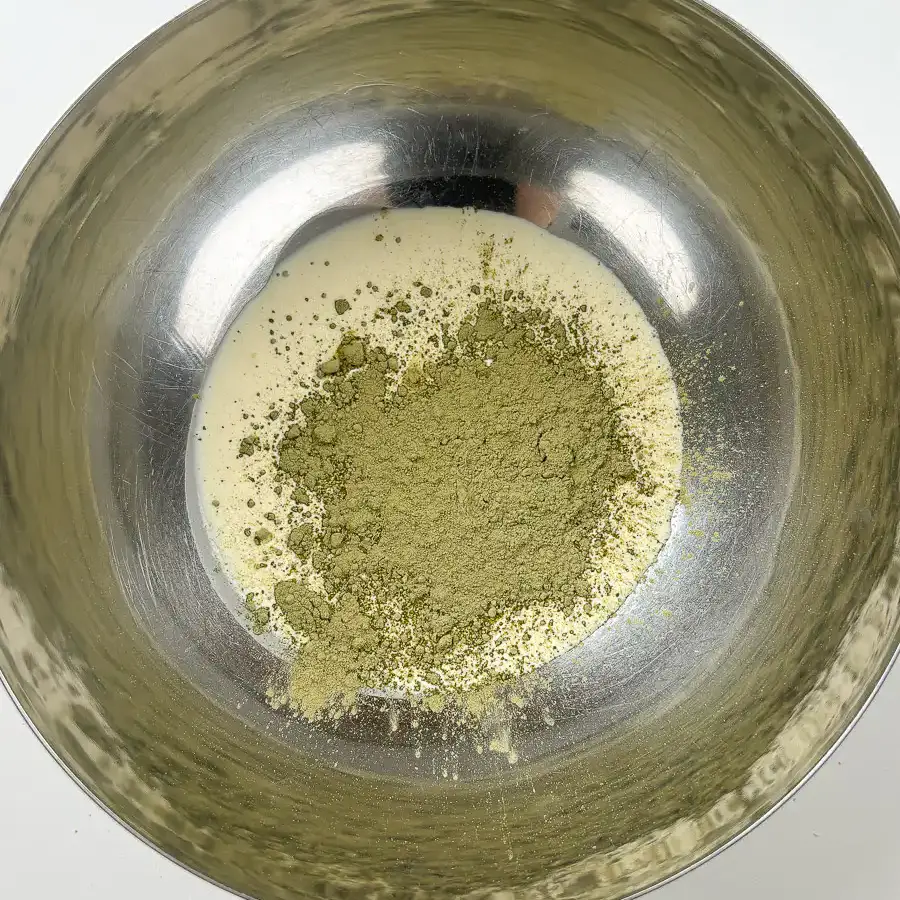 Viral Strawberry Matcha Ice Cream Sandwich matcha powder being added to heavy cream in mixing bowl. Easy matcha ice cream recipe