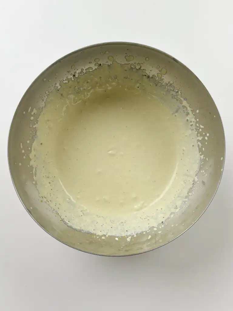 matcha cream being whipped to yogurt-like consistency in stand mixer to make matcha ice cream sandwich