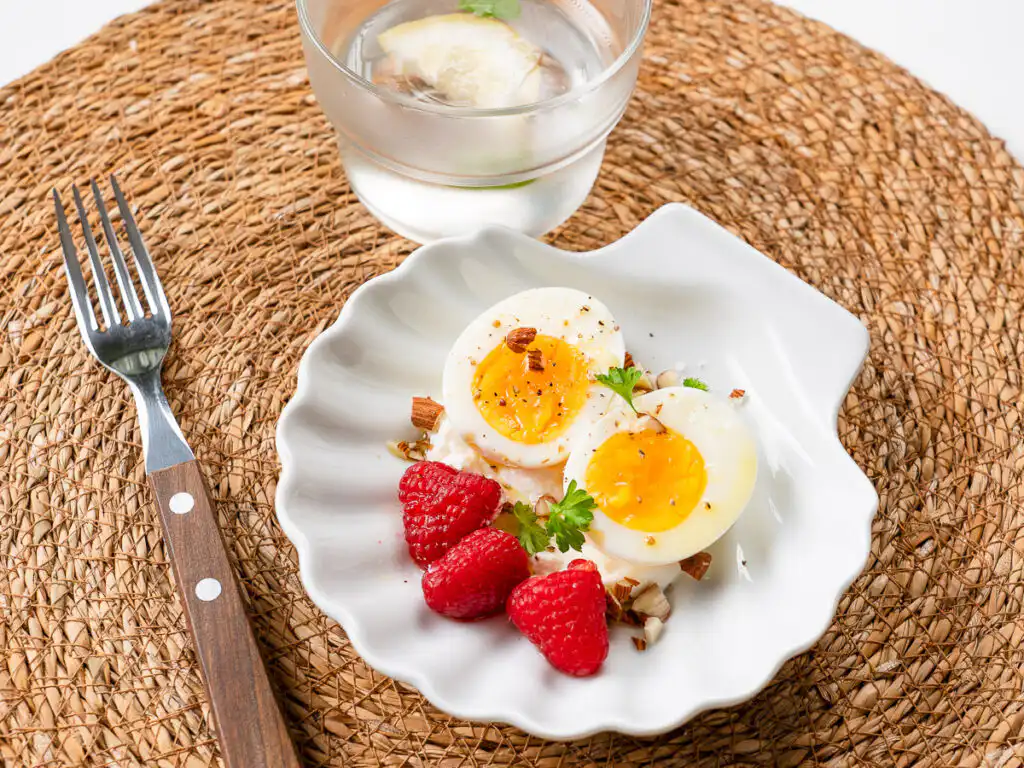 Natural Wegovy Healthy Egg Breakfast: GLP-1 Food fork resting on natural wegovy egg breakfast plate about to eat morning meal