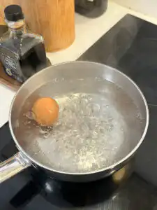 Natural Wegovy Healthy Egg Breakfast: GLP-1 Food timer set 8 minutes on phone beside pot of boiling eggs healthy egg breakfast