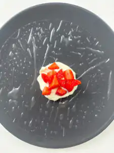 adding strawberry cubes on top of greek yogurt rice paper