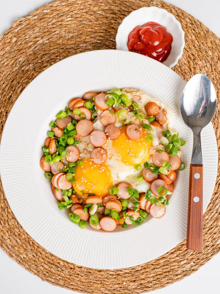 Sausage and Rice Recipe: 5-Min Korean Sausage Butter Rice sausage and rice recipes Korean style, soy-butter glazed bowl with runny egg, green onion, sesame seeds, overhead