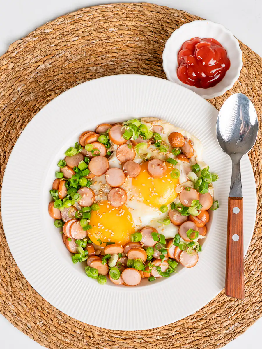 Sausage and Rice Recipe: 5-Min Korean Sausage Butter Rice sausage egg rice bowl close-up with yolk and ketchup