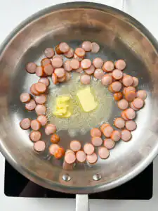 Sausage and Rice Recipe: 5-Min Korean Sausage Butter Rice Butter melting around golden sausage slices in pan for sausage butter rice, caramelising at edges