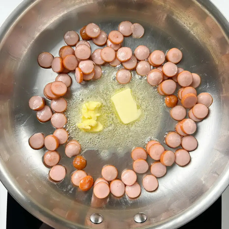 Sausage and Rice Recipe: 5-Min Korean Sausage Butter Rice Butter melting around golden sausage slices in pan for sausage butter rice, caramelising at edges