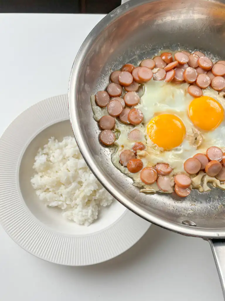 Rice bowl assembly: rice first, then sausage and rice recipes Korean egg and sausage slid on top with all sauce