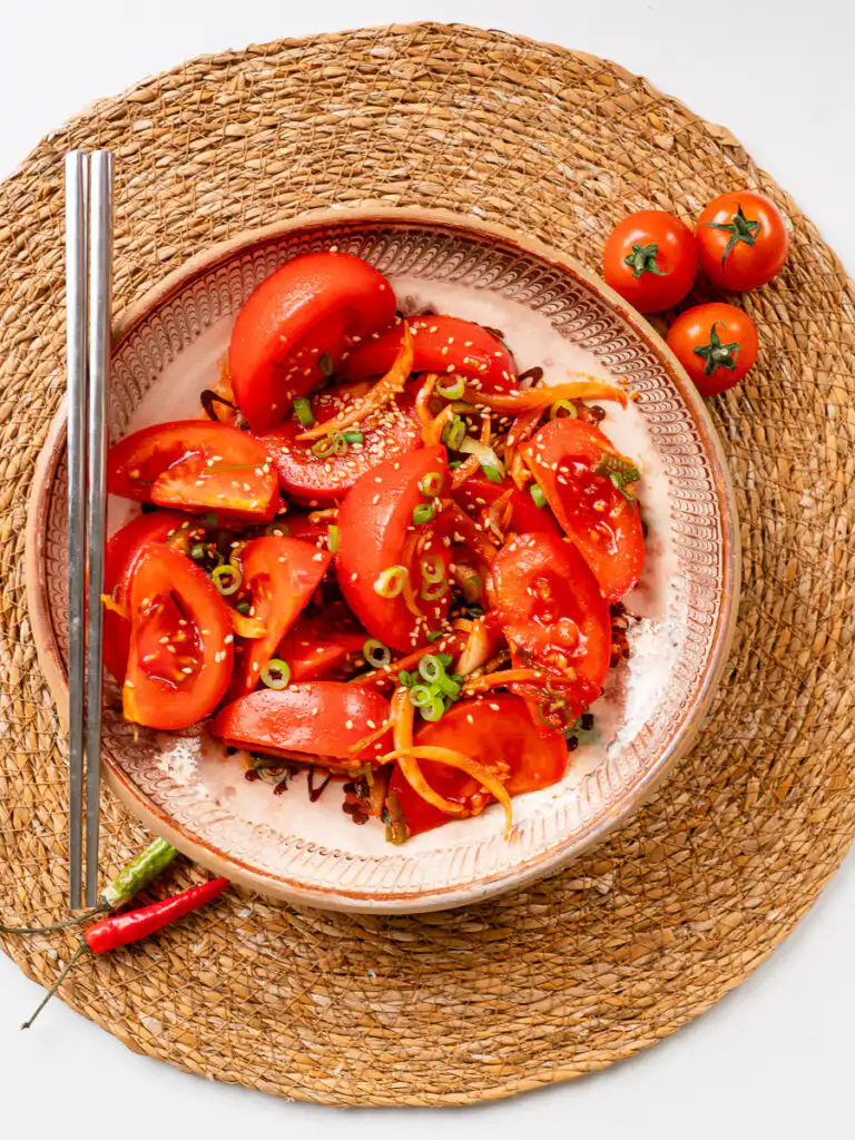 Tomato Kimchi Recipe: No Fermentation, Ready in 10 Minutes tomato kimchi recipe eaten with metal Korean chopsticks