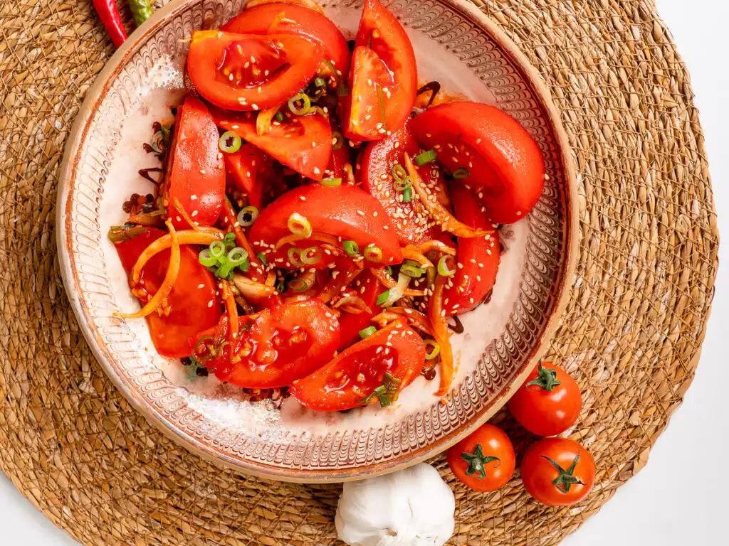 Tomato Kimchi Recipe: No Fermentation, Ready in 10 Minutes fresh kimchi recipe tomato version lifestyle shot on wooden table