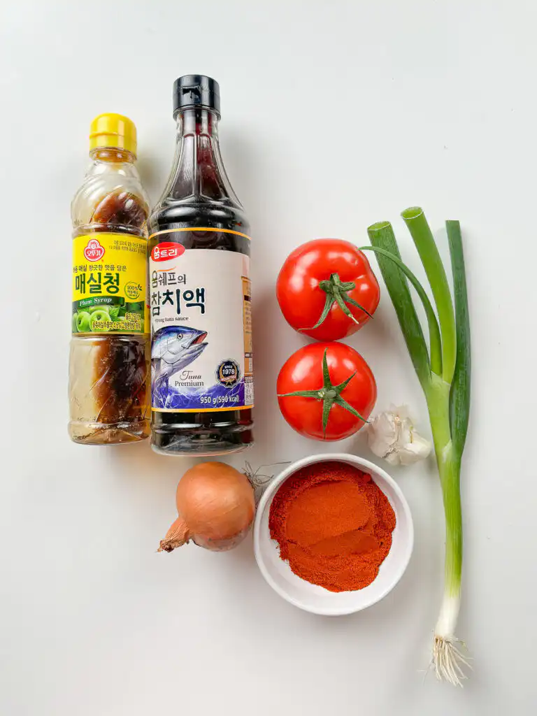Tomato Kimchi Recipe: No Fermentation, Ready in 10 Minutes tomato kimchi recipe ingredients flat lay gochugaru maesil cheong fish sauce