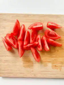 Tomato Kimchi Recipe: No Fermentation, Ready in 10 Minutes cutting tomatoes into wedges for quick kimchi recipe