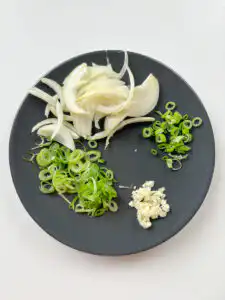 Tomato Kimchi Recipe: No Fermentation, Ready in 10 Minutes sliced onion and minced garlic for tomato kimchi recipe